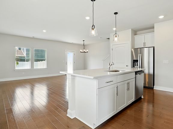 Kitchen - Spacious kitchen featuring a large island with built-in sink, abundant natural light, and an open layout ideal for entertaining.
