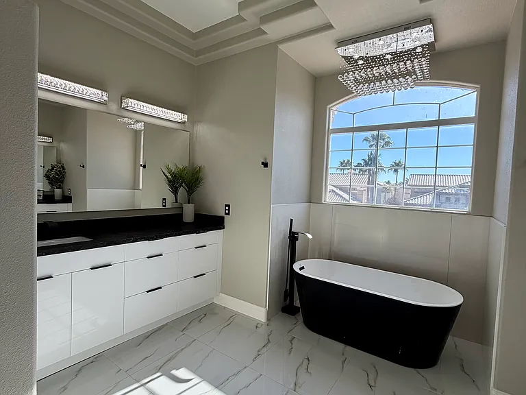 Left side: European-style vanity with high-gloss white cabinets and granite counters
