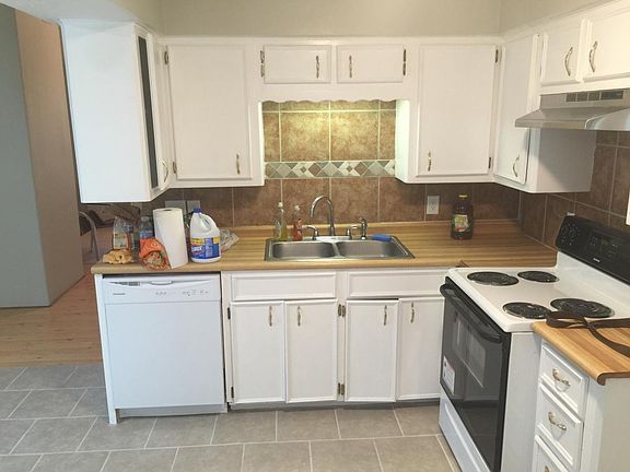 The kitchen, new dishwasher, stove and range hood.