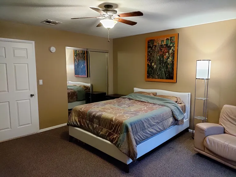 Upstairs back bedroom with private balcony.