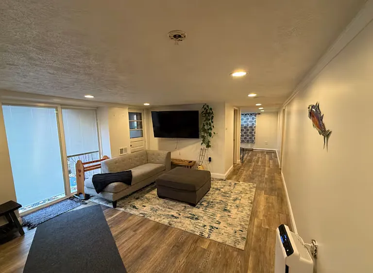 Bright and spacious living area with recessed lighting and modern flooring _ perfect for relaxing or entertaining.