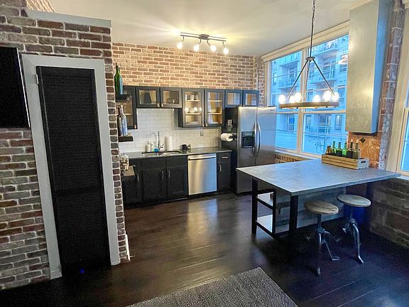 Large kitchen with island, stainless appliances, seating, and tons of storage