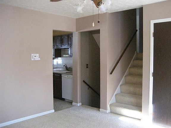 Living Room in neutral tones with wall-to-wall carpet.