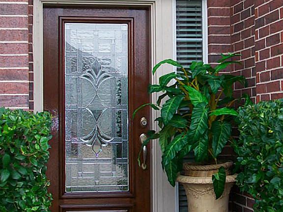 BEVELED GLASS DOOR & BRICK LANDING