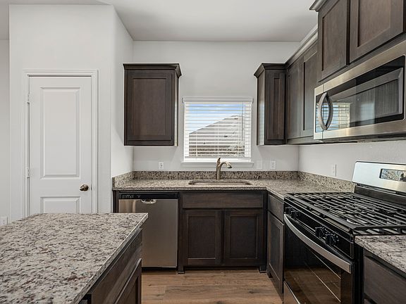 The kitchen has beautiful wood cabinetry.