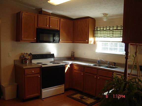 LARGE KITCHEN W/HARDWOOD FLOORS, CABINETS GALORE, AND SEPARATE EATING AREA