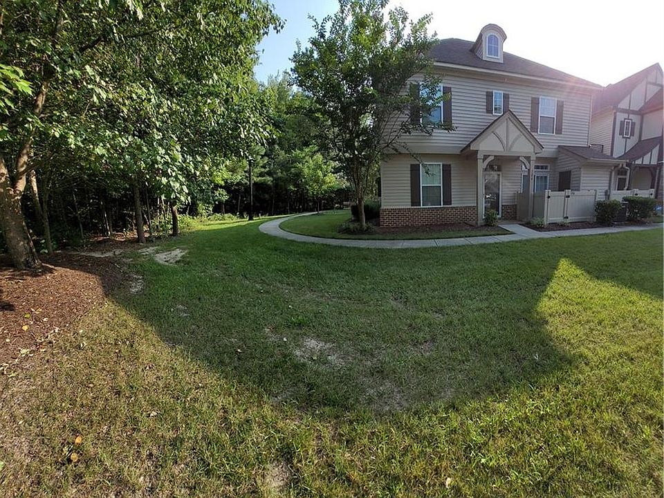 End unit with a large lot and view of the woods.