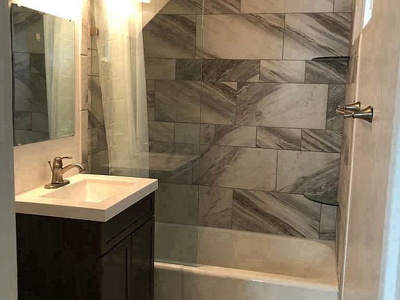 bathroom with tub and shower