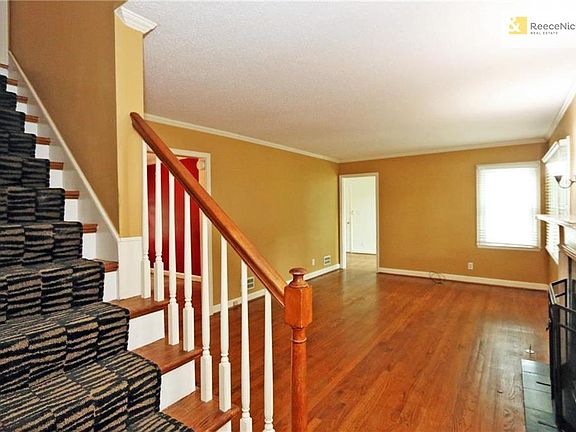 Lovely staircase on side of living room takes you to two more bedrooms and a bathroom.