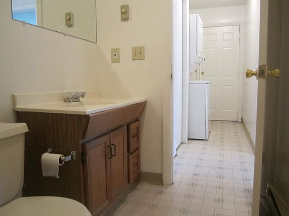 Bathroom with washer/dryer in hallway