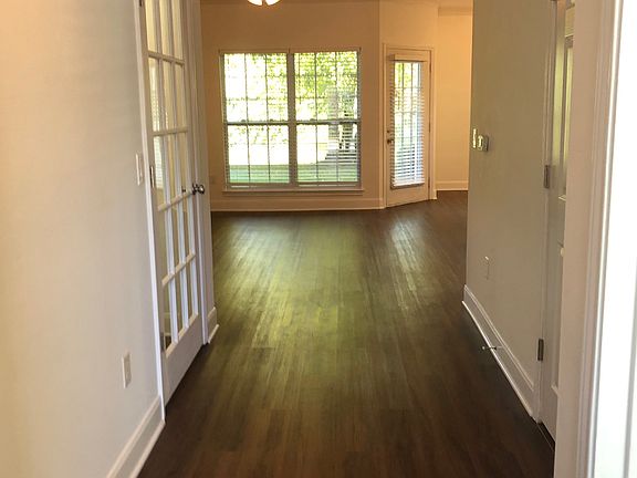 View from front door down hall. Storage closet with glass door on the left and bedroom and bathroom on the right.