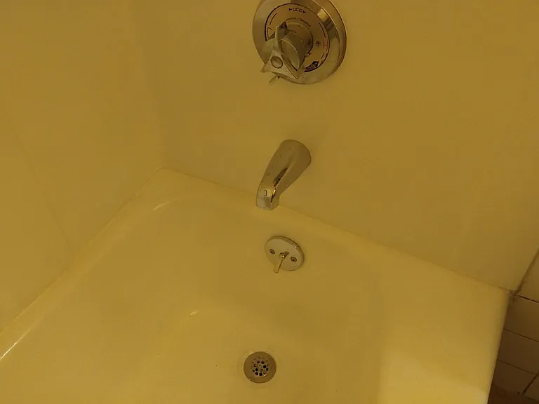 Newly refinished tub is actually nice and white with new bar