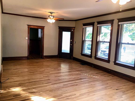 Living room - guest bedroom door on far side of the room by the front door. Wood floors throughout the main floor. A recent comment from a viewing "This room is bigger than it looks in the photos!"