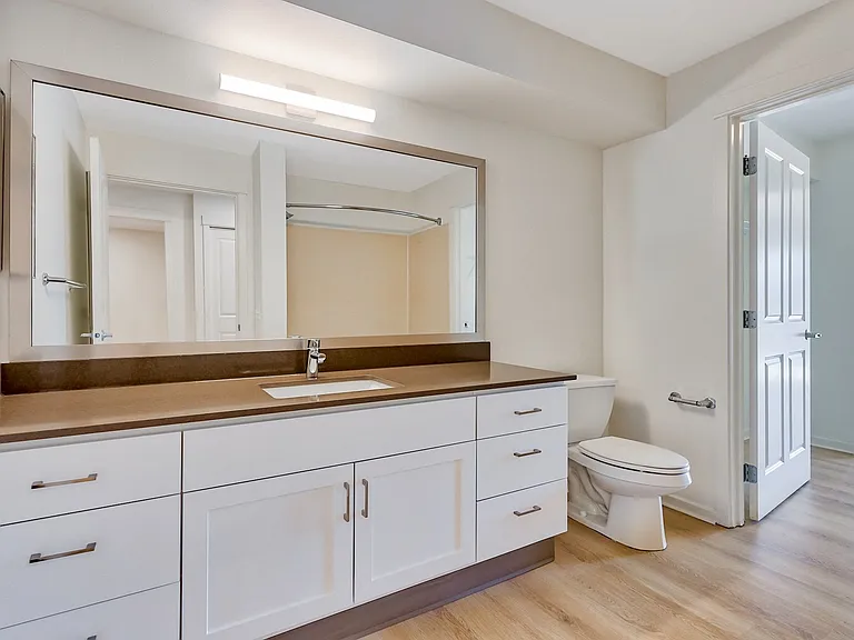 Renovated bathrooms with granite counters and undermount sinks