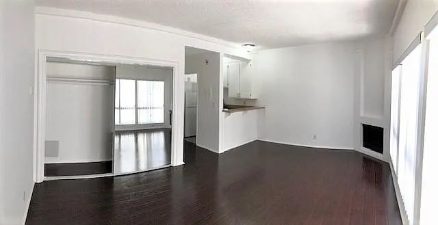 Living space with closet space and open kitchen.