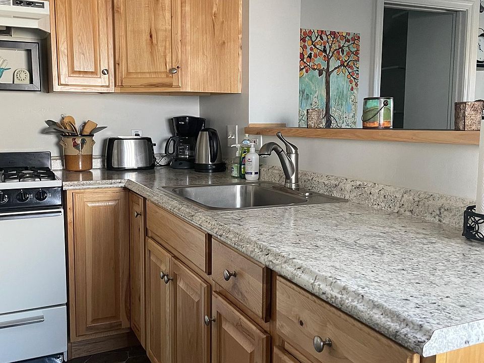 Kitchen with knotty pine cabinets, nice counters.