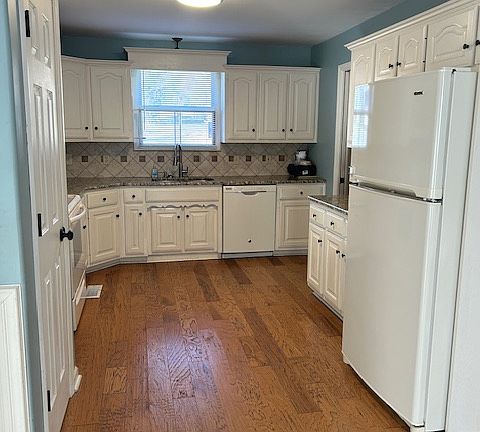 Large kitchen with granite countertops and tile backsplash. All appliances included.