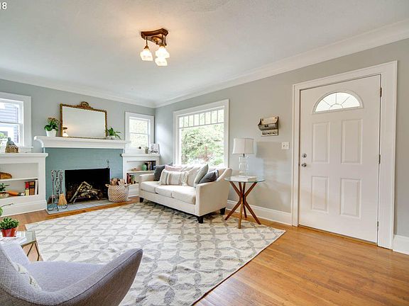 Front door enters directly into living room space with fireplace and great light - original hardwood floors throughout house