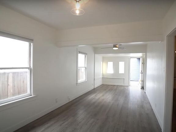 Front door pictured in the distance. To the right you access the bathroom and bedrooms (one to the left and one to the right).