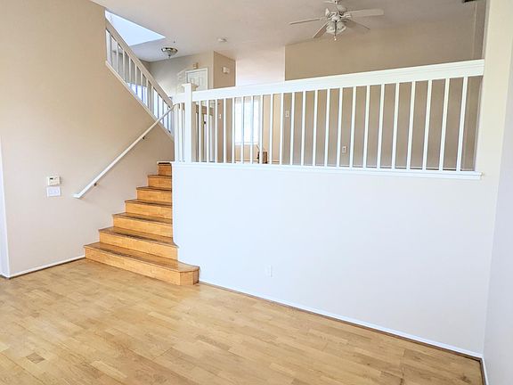 Living room space looking up to the 2nd floor balcony