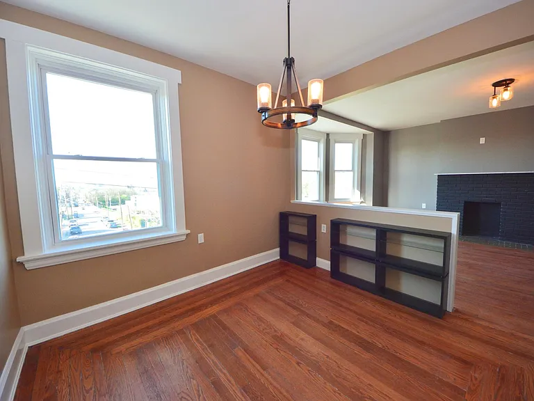 Half wall with bookshelves between living and dining, makes it super easy to furnish.