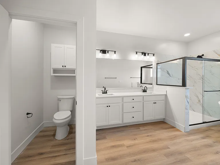 Primary bedroom private toilet room and en-suite bathroom (2-bedroom floorplan)