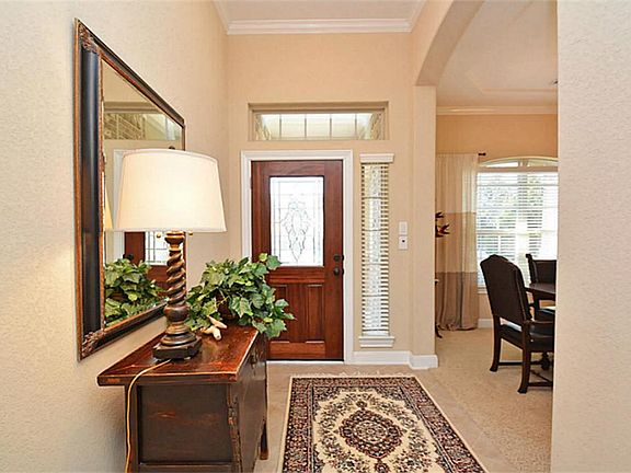 Upon entering you will notice the high ceilings, crown molding, tile floors set on the diagonal.