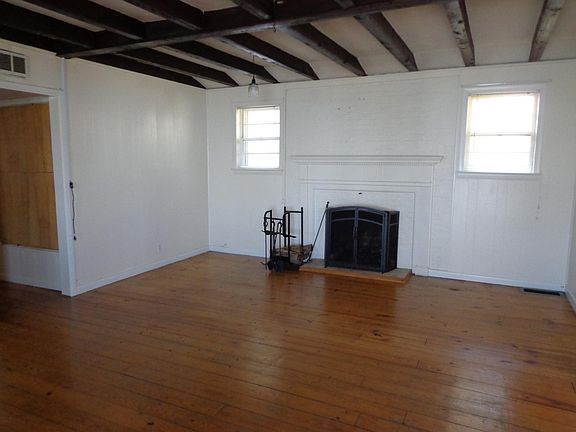 Fireplace, hardwood floors, beamed ceiling