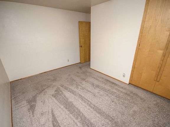 Alternate view showing the midcentury wood closet doors.