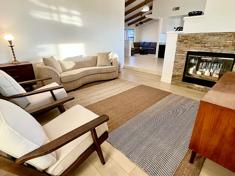The secondary living room features a see through fireplace. Could be repurposed as a kids playroom as needed.