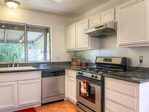 Kitchen features granite counter tops and stainless appliances