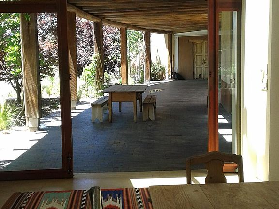 Portal with mature trees, doors are 10 ft. pocket doors to integrate indoor outdoor space.