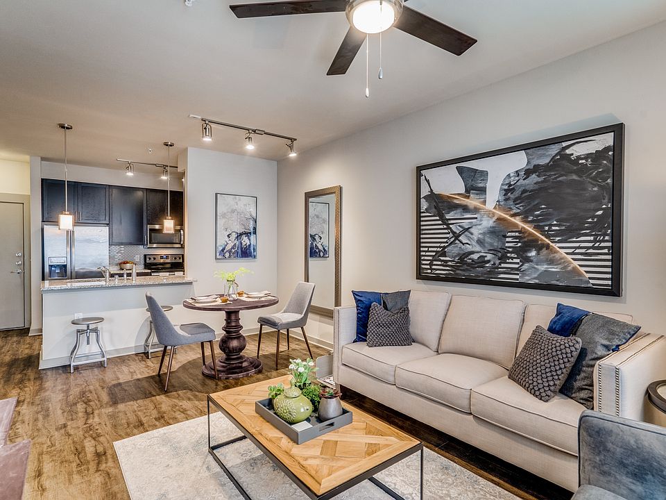 modern living room with wood plank flooring and natural lighting in Plano