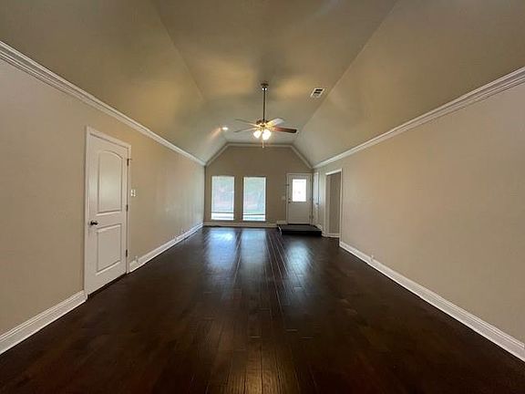 Bonus room with visible vents, baseboards, ceiling fan, lofted ceiling, and dark wood-style floors