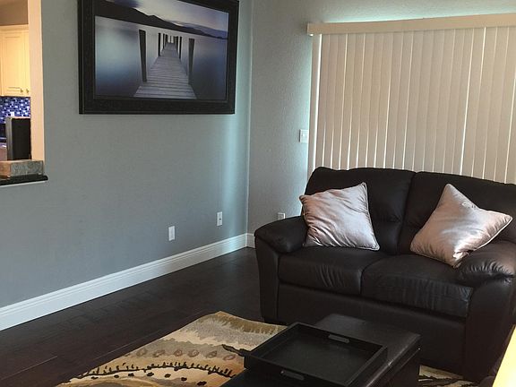 Access the lanai behind the sofa. An additional leather recliner is provided that is not currently pictured.