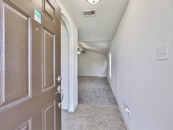 Walk through the doorway of your new home into a bright and airy entryway.