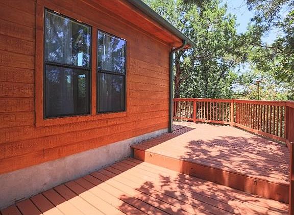 ANOTHER VIEW OF THE WRAP AROUND DECK.  PANORAMIC VIEWS FOR DAYS FROM THIS GORGEOUS HILL SIDE HOME.