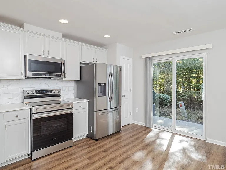 In addition to the beautiful kitchen, enjoy the scenic trees and peaceful backyard.