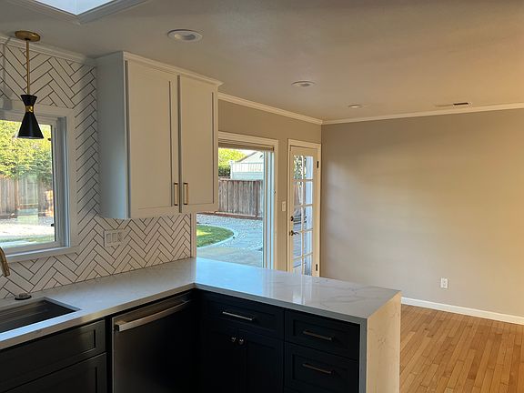 View from kitchen to dining area and view of backyard