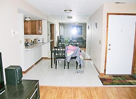dinning rm with back mirror on back wall