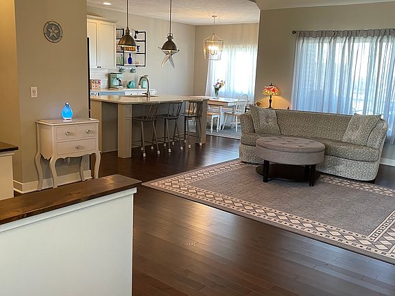 View of living/kitchen/dining area from front door of residence.
