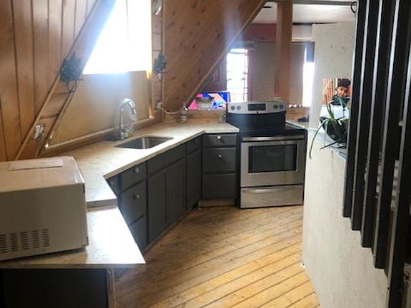 the modern kitchen as you come in thru the entry way. vaulted ceilings above