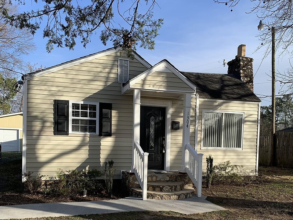 Front of house with view of garage on left.