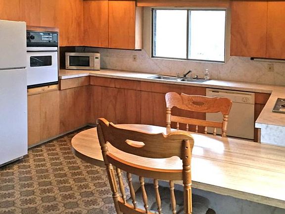 The kitchen is huge with tons of cabinets and a lot of counter space.  There is a built-in eating area that overlooks the backyard.