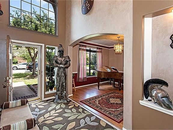 Entry with high ceilings and venetian plaster on walls