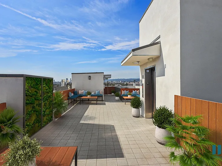 Rooftop Deck with Entertainment Space and Views of the City