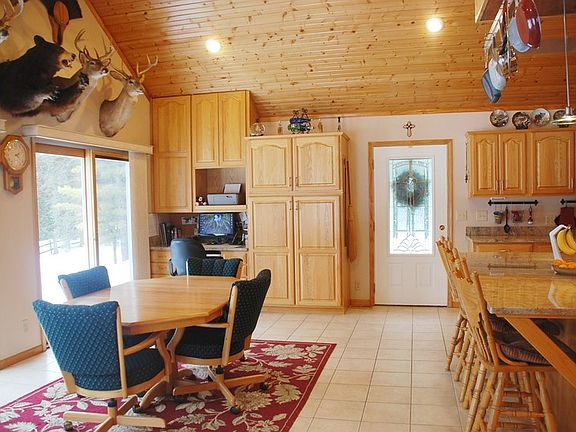 Kitchen Table
						:
						Built in desk, seat 4 at Island, two sliders to deck, side exit door.
