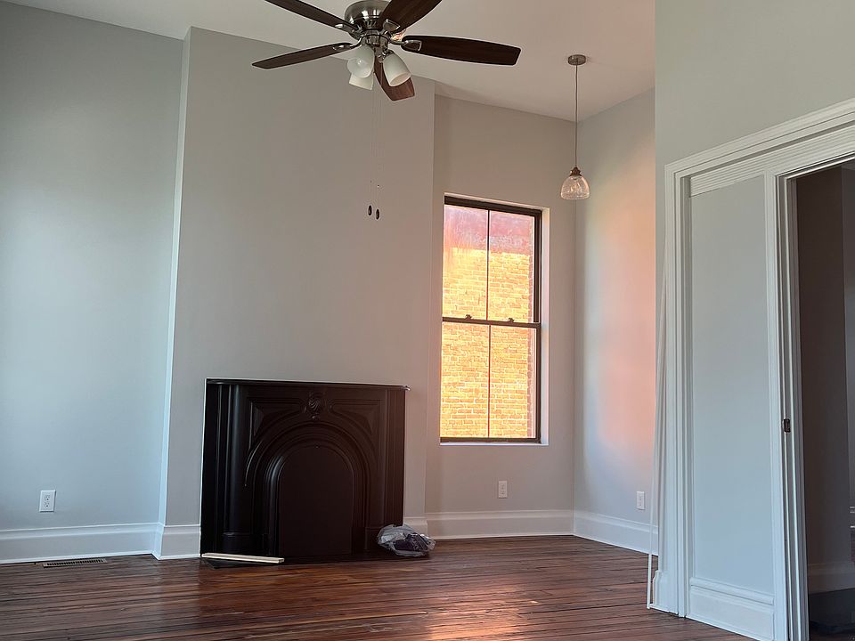 Original hardwood flooring and decorative fireplace