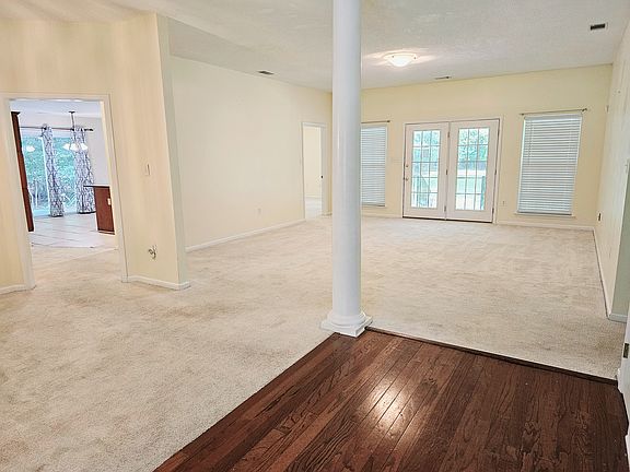 Spacious open floor plan. Living room/dining area great room. View to kitchen and backyard.