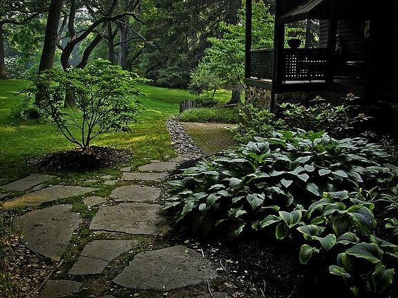 Left side of house, stone path to patio